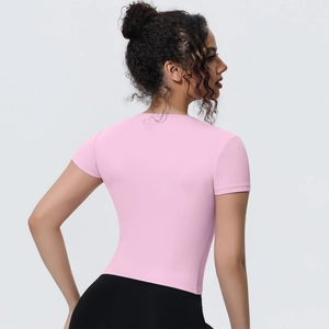 Back view of slim fit pink yoga crop top showing breathable stretch fabric and athletic cut