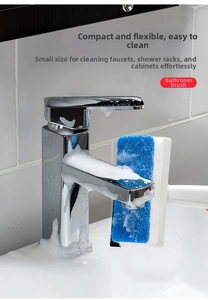 Detail of the blue fiber brush cleaning a faucet with rich soap foam in the bathroom