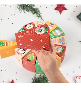 Detail of triangular Christmas gift boxes in cake slice shape with festive prints
