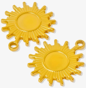 Macro shot of two golden sun-shaped 304 stainless steel pendants with metallic luster