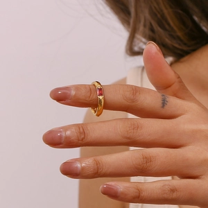 Close-up of a gold-plated stainless steel ring featuring a rectangular red zircon stone
