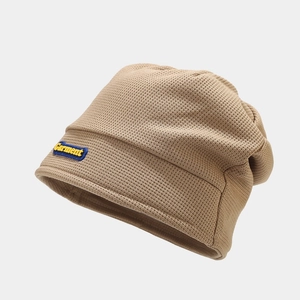 Detail view of khaki waffle knit texture and Garment embroidery patch on winter beanie hat