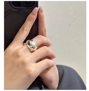 Close-up of a wide minimalist S925 sterling silver ring worn on a finger