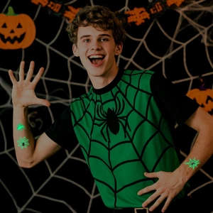 Luminous Halloween spider tattoos and web stickers on model in a festive pumpkin setting