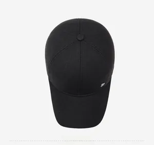Top view of a black wool baseball cap for men featuring a metallic badge detail