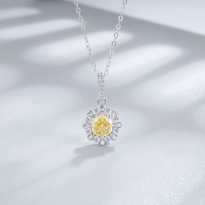 Macro detail of sunflower pendant with yellow ice-cut diamond and silver chain