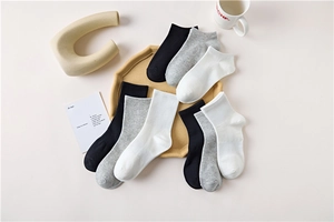 Detailed flat lay of cotton socks in black grey and white featuring crew and ankle styles