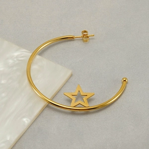 Minimalist gold stainless steel hoop earrings with star motif on a neutral background