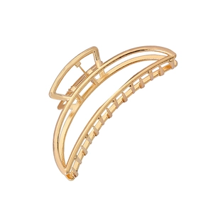 Large golden geometric hollow metal hair claw clip with minimalist crescent design