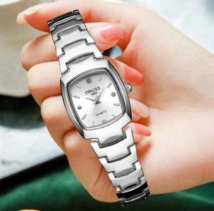 Macro shot of silver tonneau quartz watch with diamond markers and stainless steel strap