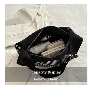 Spacious interior of black pillow bag showing phone, wallet and umbrella storage