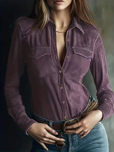 Detailed texture of purple faux suede shirt featuring dual pockets and metallic buttons