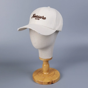 Vintage beige cotton baseball cap with brown letter embroidery and distressed brim detail