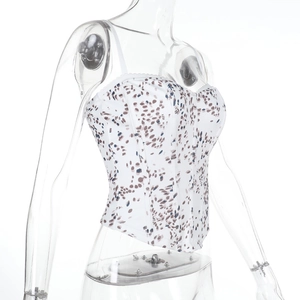 Detailed view of women's floral crop top with thin straps and abstract colorful patterns
