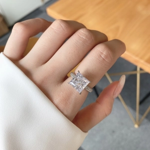 Macro shot of princess square cut carbon diamond and pavé-set silver band for women