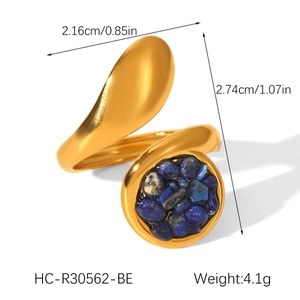 Detail view of gold open ring with blue natural stone inlay and artistic streamline design