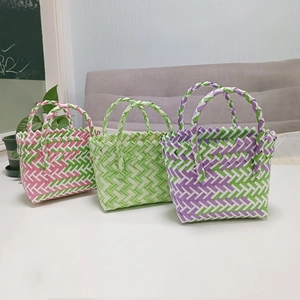 Macro detail of hand-woven plastic mini baskets with colorful diamond weave patterns