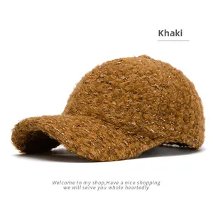 Close-up of the textured khaki lambswool fabric and warm stitching on the baseball cap