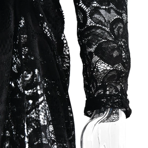 Detail of sheer black lace fabric on sleeve showing intricate floral patterns and texture