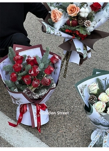 Christmas bouquets with roses and pine cones wrapped in Santa themed holiday papers