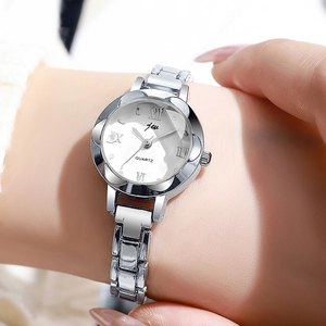Detail of elegant silver women watch with white dial and Roman numerals on a wrist