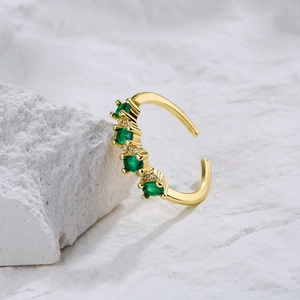Minimalist 18K gold plated open ring featuring four round green zircons on a white stone base