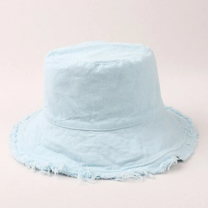Detail of light blue cotton canvas bucket hat featuring vintage frayed edges and texture