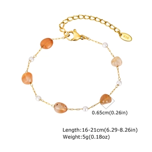Detail of gold chain bracelet with orange raw stones, white pearls, and K18 hallmark tag