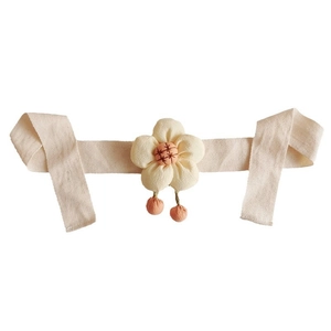 Floral curtain tieback with beige fabric flower and orange tassels for children's room decor