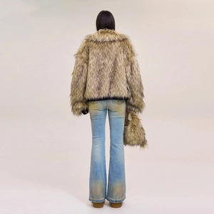 Rear view of distressed light blue flare jeans paired with a faux fur cropped jacket