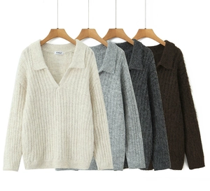 Detailed macro view of V-neck knit sweaters in four colors with ribbed cuffs and collar