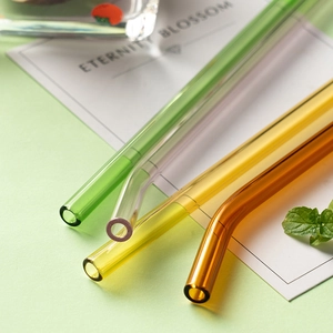Colorful heat-resistant borosilicate glass straws in green, yellow, and amber bent shapes