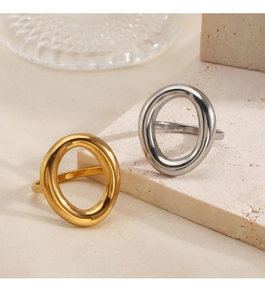 Macro shot of 18K gold and silver hollow oval rings on a minimalist stone display stand