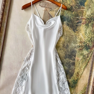 Elegant white satin slip dress with cowl neck and lace side panels on a vintage hanger