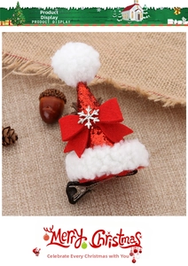 Detail of Christmas hat hair clip with red sequins, white fur trim, and snowflake charm