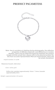Macro detail of S925 sterling silver heart charm bracelet with oval bead chain links