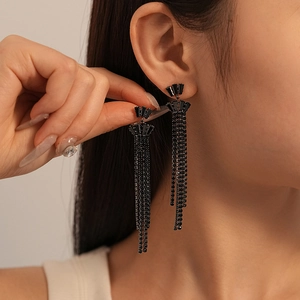 Close-up of black rhinestone long tassel earrings with a fan-shaped geometric stud