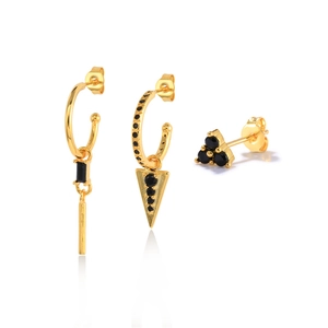 Detailed view of 3-piece gold earring set featuring geometric black stones and polished finish