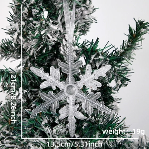 Detail of 21cm acrylic snowflake ornament with glitter on a snowy Christmas tree