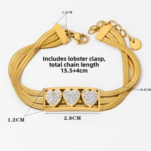 Detail of gold multi-layer snake chain bracelet with heart-inlaid rectangular plate