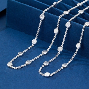 Polished 925 sterling silver beaded necklace with brushed metallic discs on blue velvet