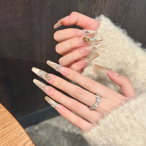 Champagne cat-eye press-on nails with amber rhinestones and pearls on long coffin shape