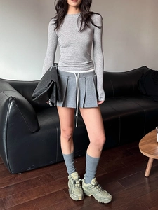 Slim fit light grey wool t-shirt paired with a matching pleated mini skirt for a chic look