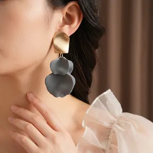 Elegant irregular petal drop earrings featuring matte gold and charcoal grey resin layers