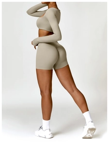Detail view of khaki long sleeve crop top and high waisted scrunch leggings set