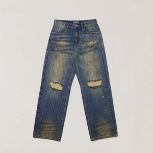 Vintage blue wide-leg jeans with distressed knee holes and heavy washed texture