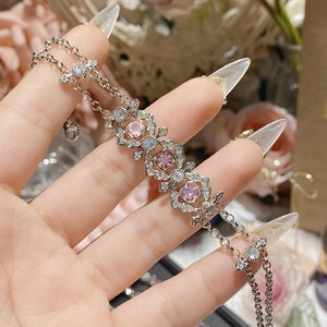 Macro detail of 18K gold plated pink square gems and sparkling zircon on a silver chain