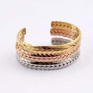 Three-piece stackable woven metal cuff bracelets in gold, silver, and rose gold finishes