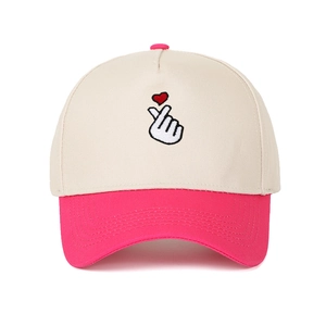 Close-up of contrast stitch baseball cap with finger heart embroidery and pink brim