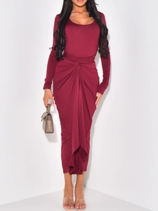 Detailed view of elegant burgundy long-sleeve dress with waist twist and irregular hem